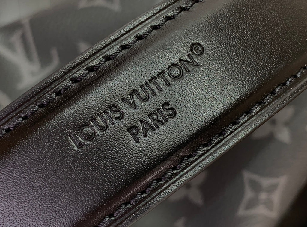 Black leather strap with embossed “LOUIS VUITTON PARIS” text