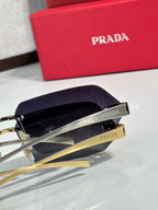 Prada sunglasses with dark purple-tinted lenses and gold-tone temple arms.