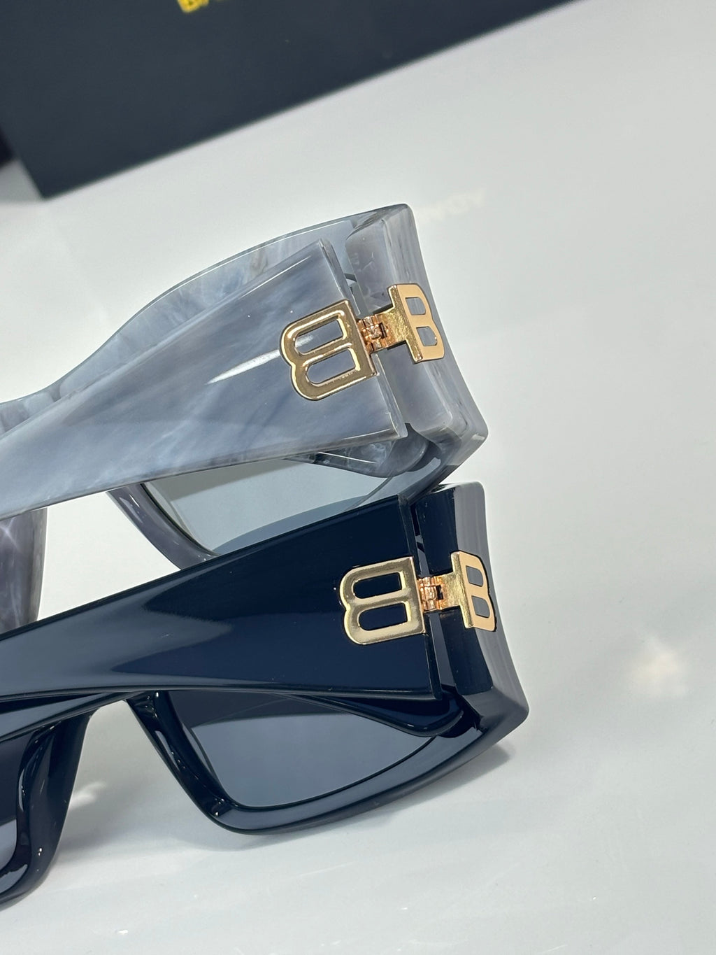 Balenciaga sunglasses temples with gold BB logo hardware on dark frames