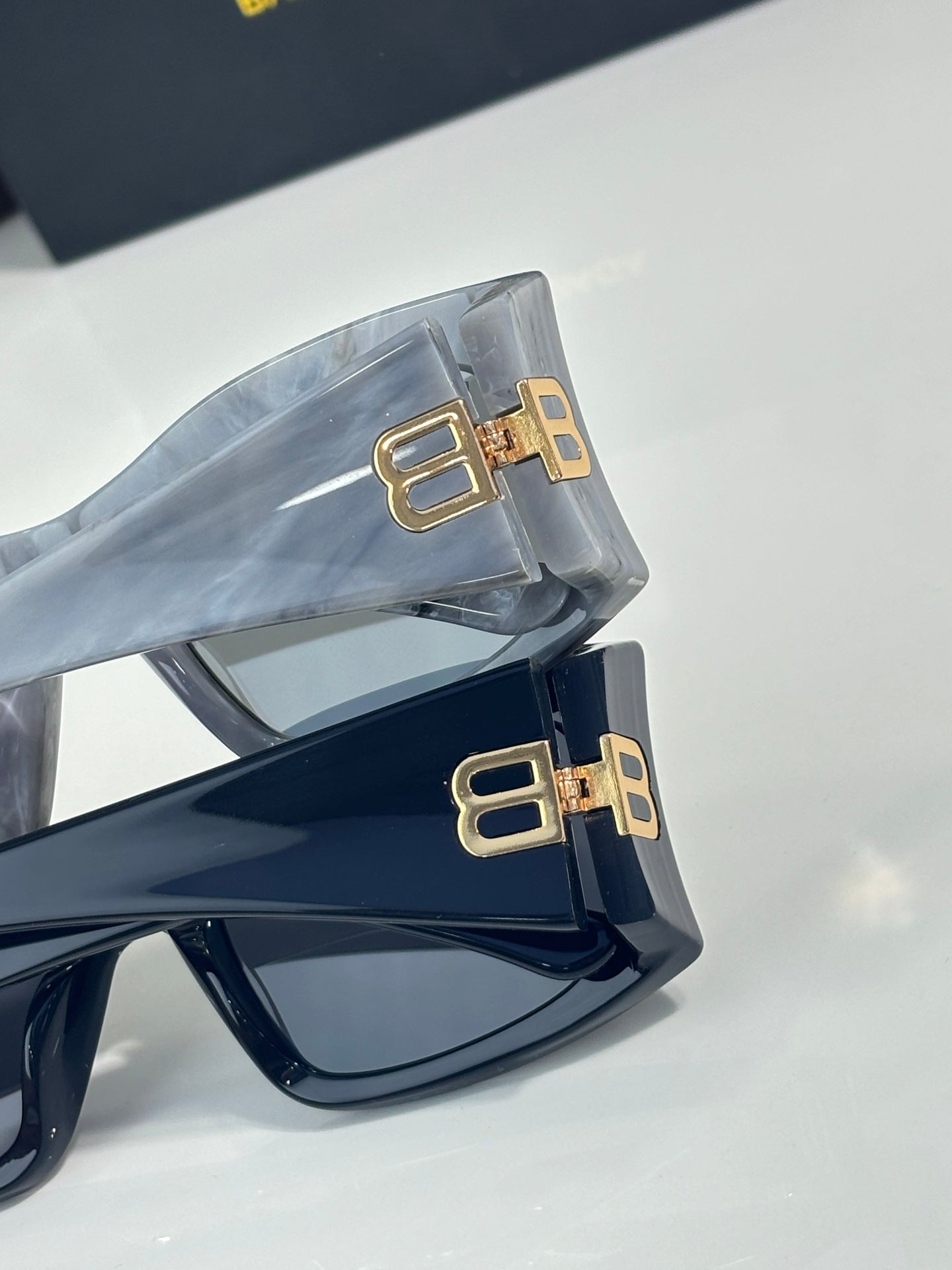 Balenciaga sunglasses temples with gold BB logo hardware on dark frames