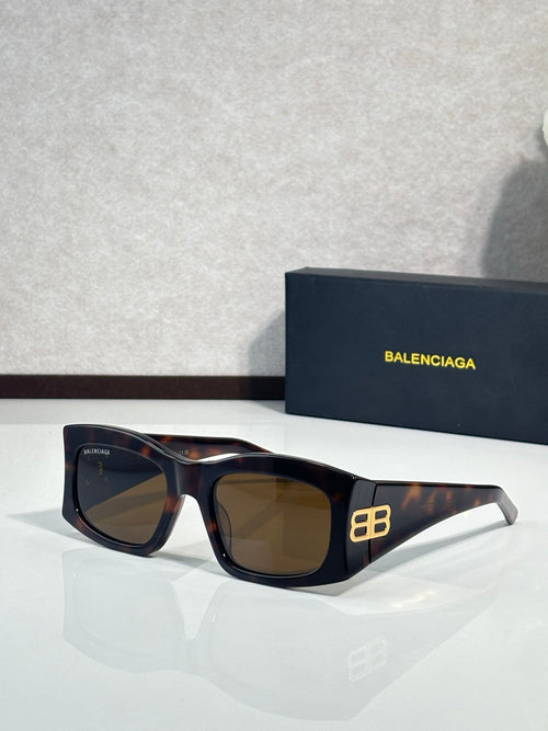 Balenciaga sunglasses with dark lenses and tortoiseshell acetate frame, gold logo detail
