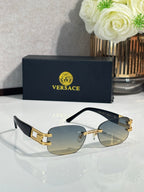 Gold-tone round sunglasses with light-gold gradient lenses and black temple arms