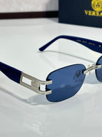 Dark blue sunglasses side view with silver-tone bridge plate and rounded dark lenses