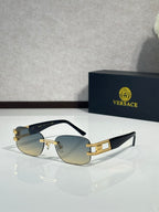 Gold-tone sunglasses with amber gradient lenses and black temple arms with logo text