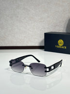 Black sunglasses with dark lenses, gold-tone bridge accents, and angular temple hardware