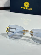 Light-blue lens sunglasses with gold-tone bridge and metal temple hardware
