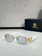 Gold-tone metal sunglasses with blue-gray gradient lenses and rectangular front detail