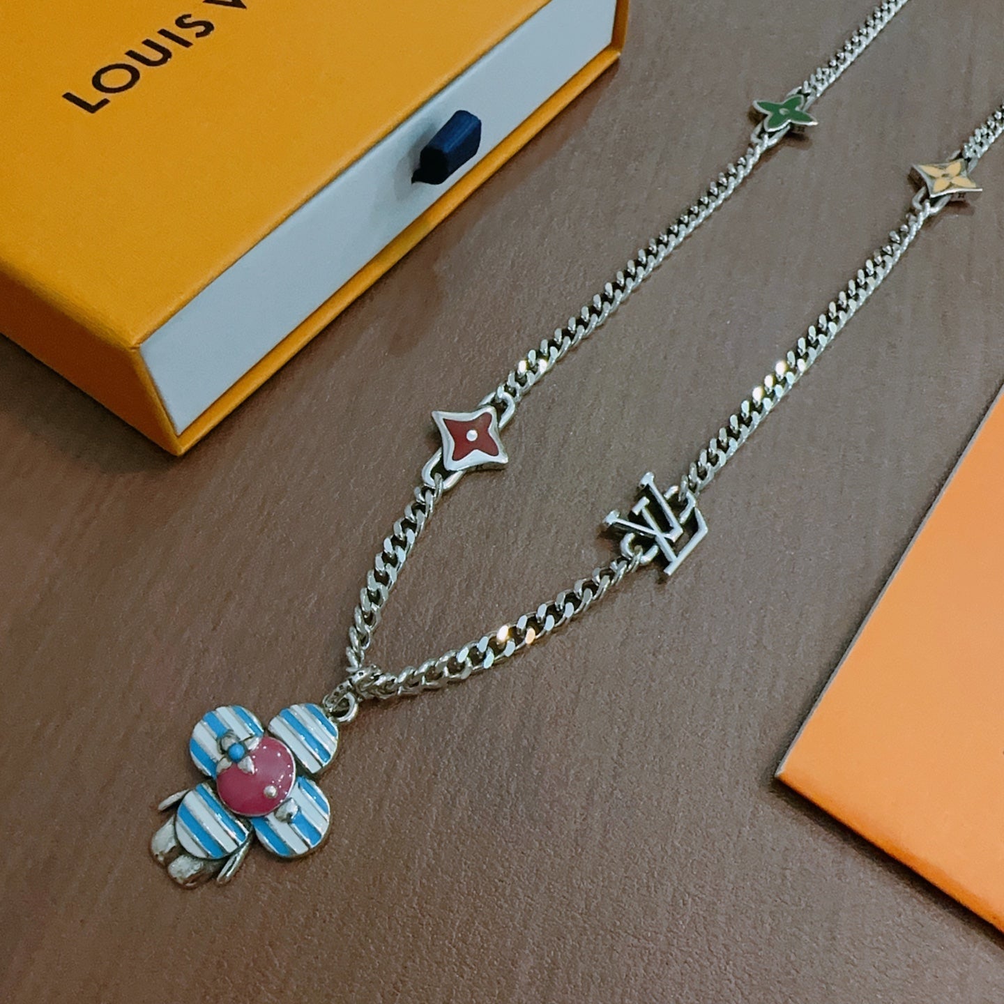 Silver chain necklace with multicolor flower charm and star/letter logo charms