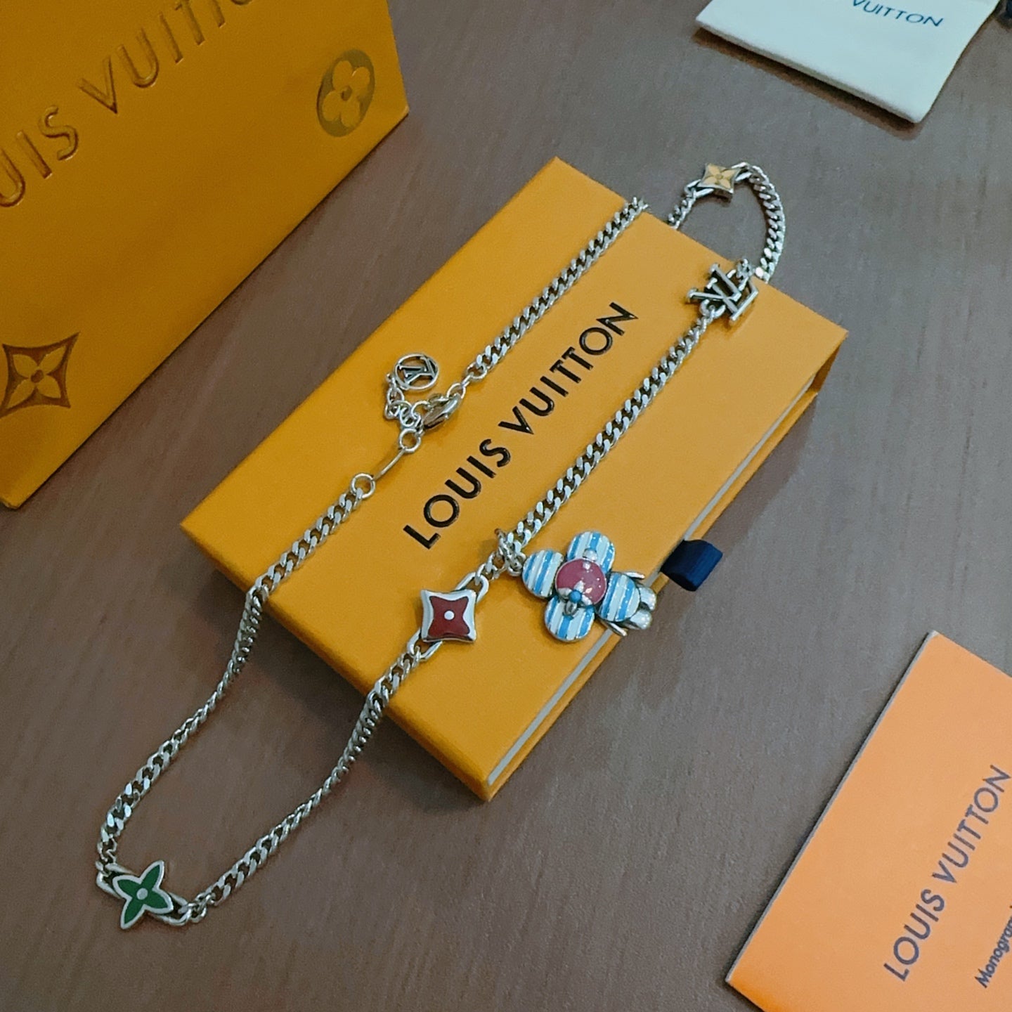 Silver charm necklace with multicolor enamel flower and star charms on chain