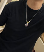 Silver-tone charm necklace with colorful character pendant and small star on chain