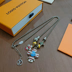 Silver-tone charm necklace with blue robot, striped character charm, and star; two chains