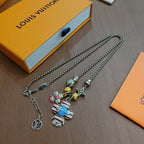 Silver-tone charm necklace with character pendants and star charm, showing lobster clasp