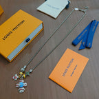 Silver-tone charm necklace with colorful character and star pendants on chain