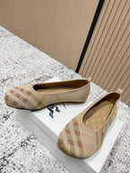 Burberry check-pattern slip-on flats, front view on a white display box