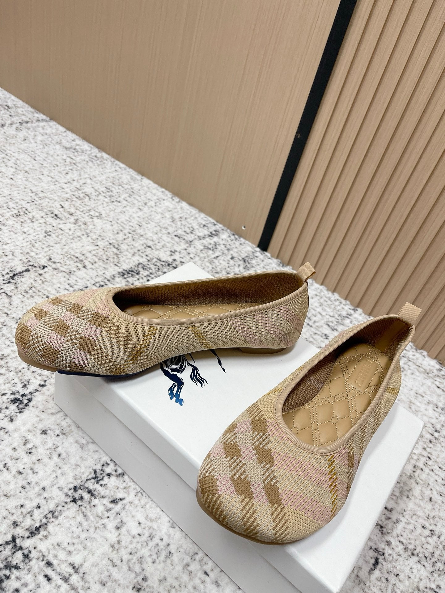Burberry check-pattern slip-on flats, front view on a white display box