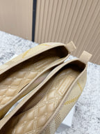 Burberry check-pattern slip-on flats, close-up of quilted insole and stitching