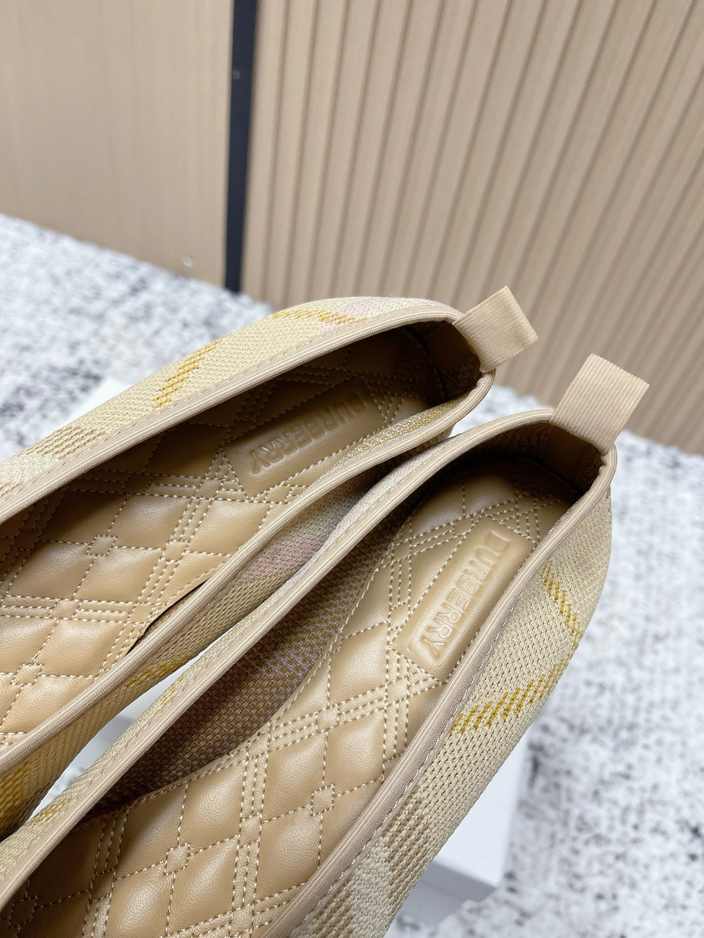 Burberry check-pattern slip-on flats, close-up of quilted insole and stitching