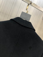 Black long coat close-up of raised collar and shoulder seam