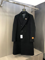 Black long double-breasted coat with notch lapels and button front, with small butterfly pin