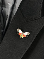 Black coat with colorful butterfly bird pin applique at chest