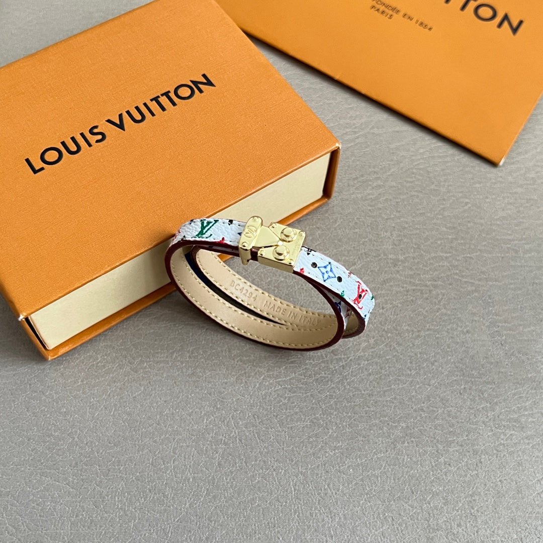 Louis Vuitton bracelet with multicolor monogram print and gold clasp, cream leather interior.