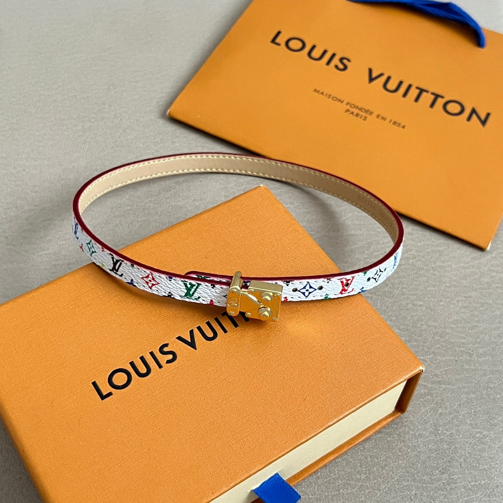 Louis Vuitton bracelet with white multicolor print and gold clasp, cream leather backing.