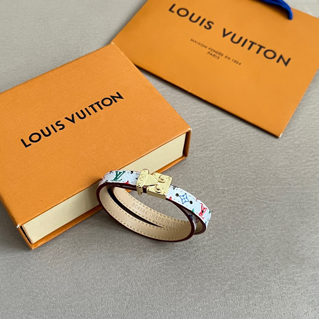 Louis Vuitton bracelet with multicolor print, cream leather edge, and gold clasp hardware.