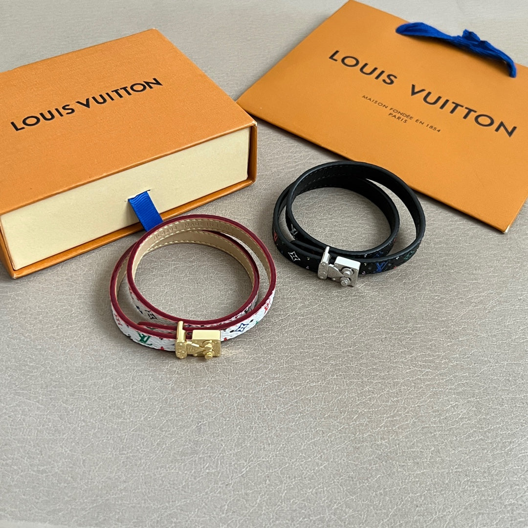 Louis Vuitton bracelets set with multicolor patterned strap and black leather strap, metal clasp.