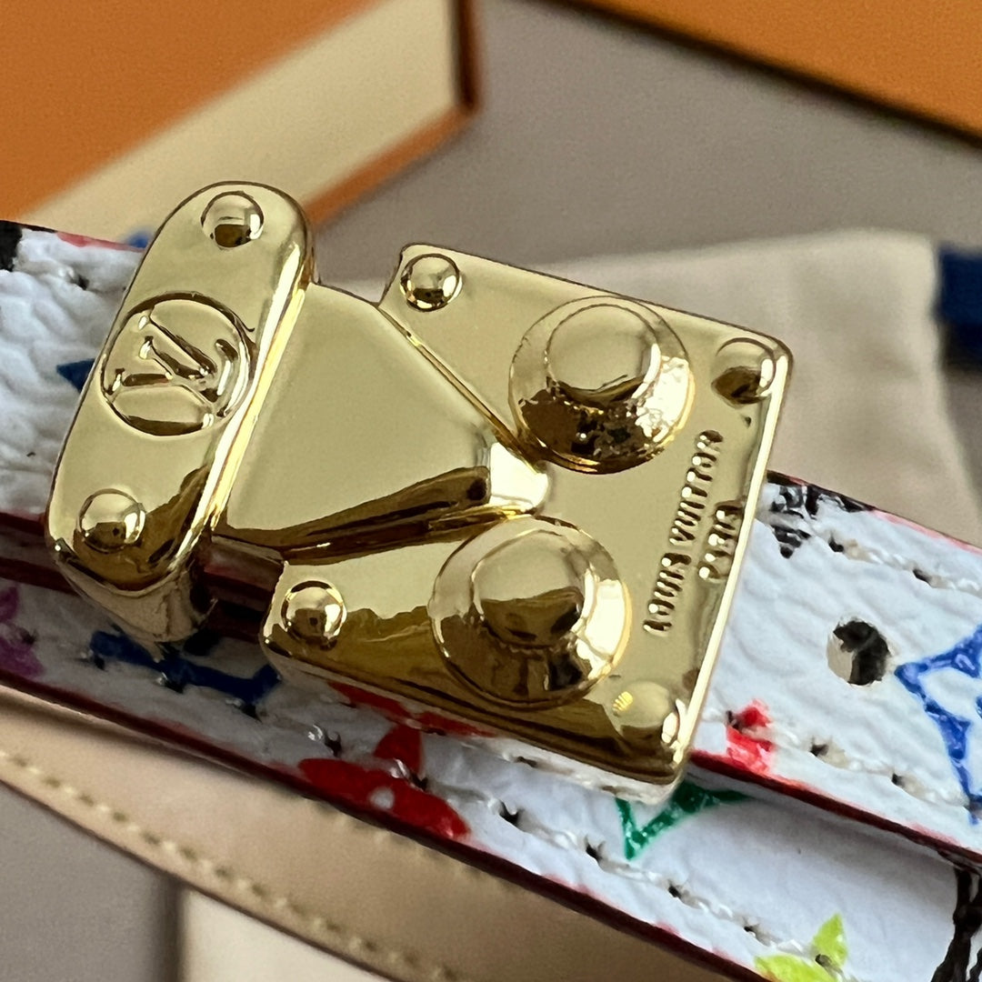 Louis Vuitton gold-tone clasp hardware on multicolor patterned leather bracelet, close-up.