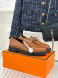 Hermes women’s loafers in tan leather with square buckle detail and dark sole