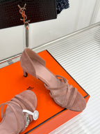 Light pink suede heeled sandals with ankle strap, side view on retail box