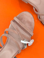 Light pink suede sandal straps with stitch detail and oval decorative charm