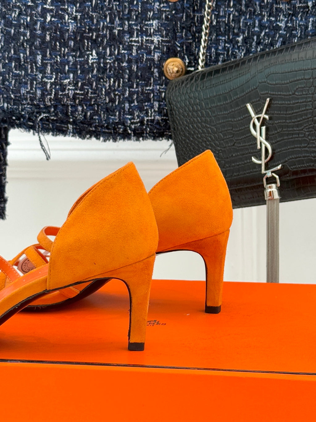 Hermes orange suede heeled sandals, side view showing slender heel and slingback strap