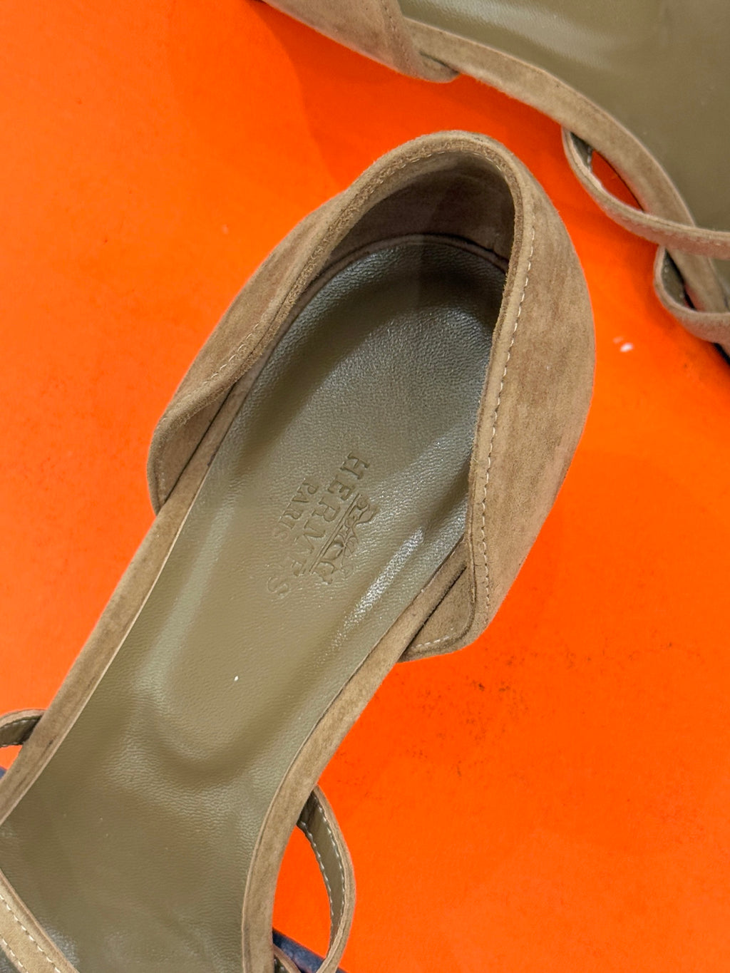 Close-up of beige suede heeled sandal toe and interior lining.