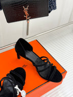 Black suede strappy high-heel sandals with thin ankle straps and stiletto heel