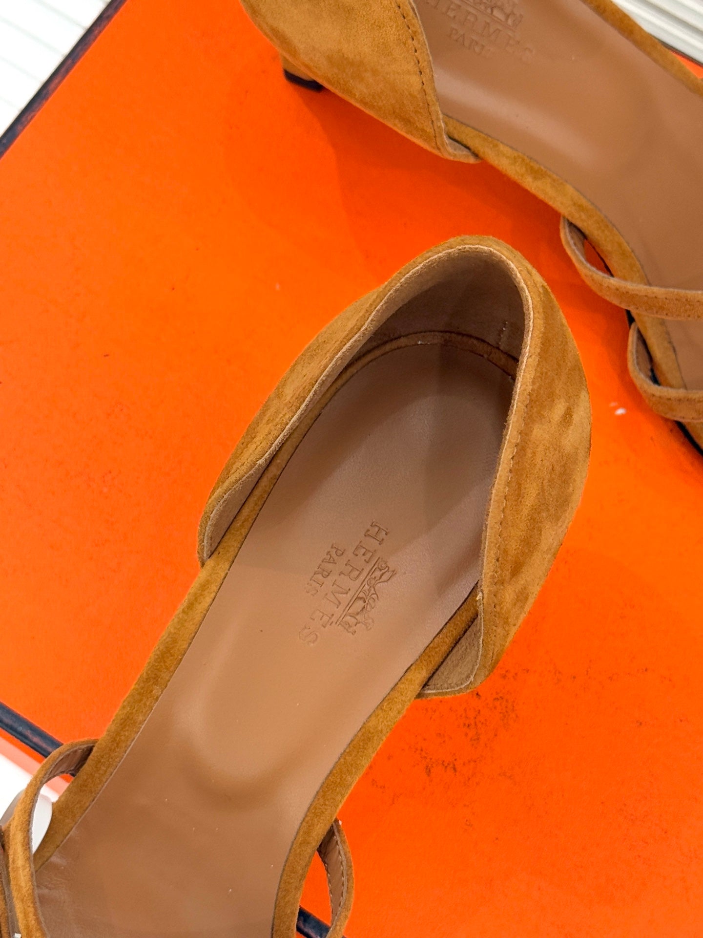 Tan suede sandal with open strap design and padded interior footbed