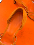 Orange suede sandal close-up of footbed and heel lining, slingback style.