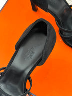 Close-up of black suede sandal footbed and ankle strap