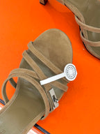 Hermes tan suede sandal detail with layered straps and round logo charm