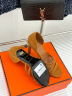 Tan suede heeled sandals with cross straps and white price tag