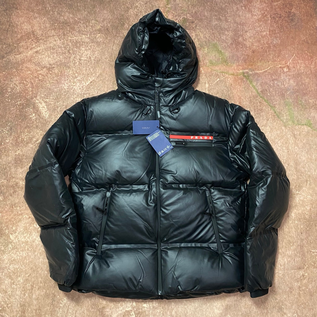 Men's long hooded puffer jacket in dark color, full zip and quilted panels