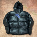 Men's long hooded puffer jacket in dark color, full zip and quilted panels