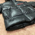 Long hooded puffer jacket close-up, zip front and quilted insulation