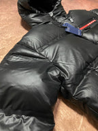 Long hooded puffer jacket quilted body close-up with side zip pocket