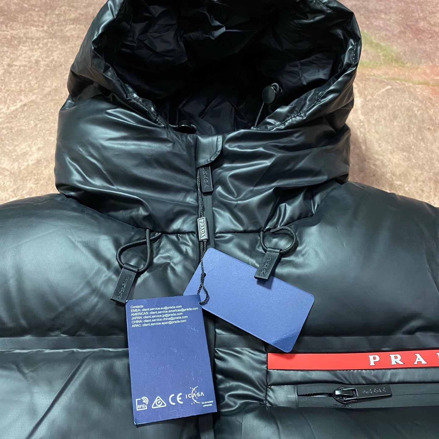 Long hooded puffer jacket hood and zip front with hanging tags and PRADA