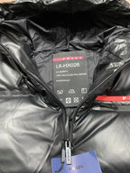 Long hooded puffer jacket inner label panel with PRADA branding