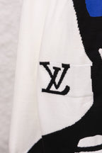 White sweater sleeve pocket area with black LV logo graphic