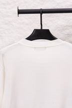 White long-sleeve crewneck sweater back view with small neckline tag