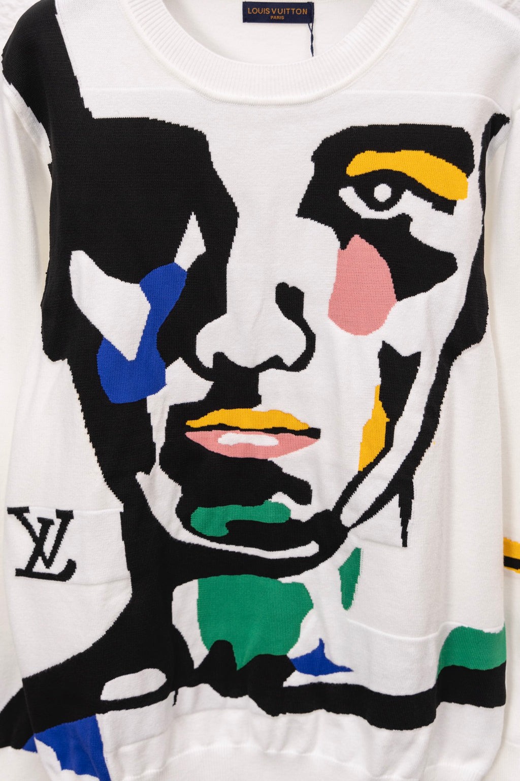 White crewneck sweater front with colorful face graphic in bold shapes
