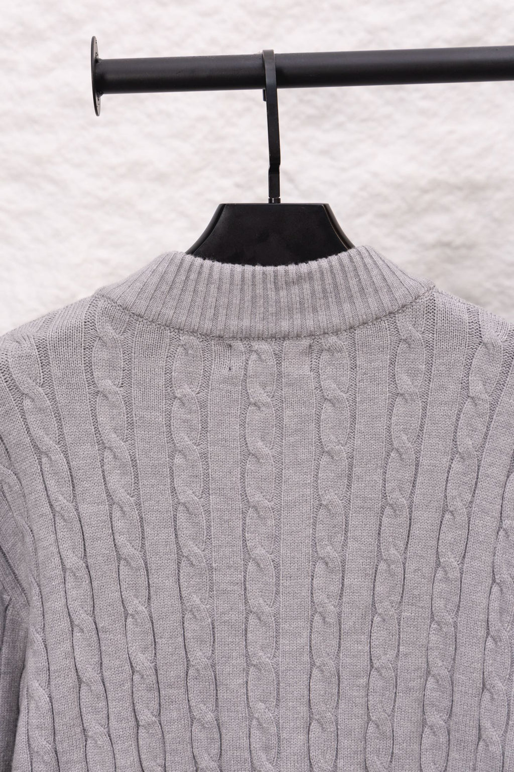Light gray cable-knit sweater back with ribbed stand collar